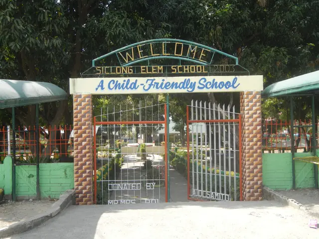 The image shows the entrance to a child-friendly school, with an arch and gate in the center, two...