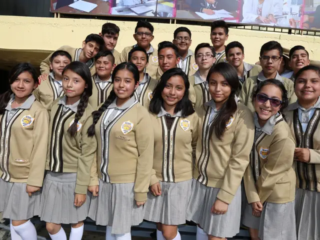 The image shows a group of children in school uniforms posing for a photo in front of a wall with a...