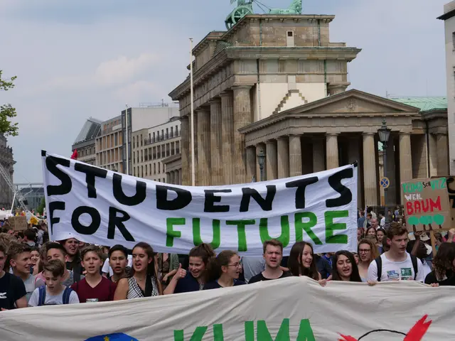 The image shows a group of students marching in Berlin, holding a banner that reads "Students for...