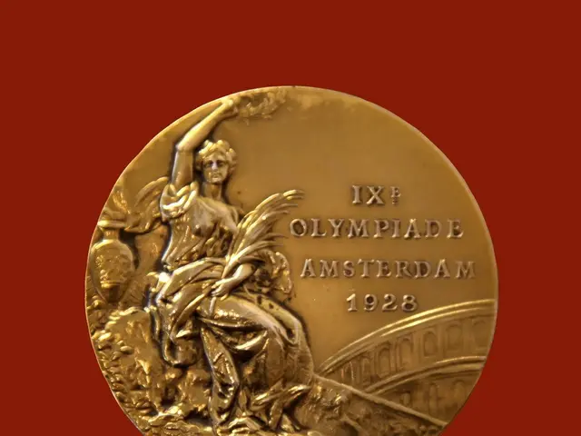 The image shows a gold medal with a statue of a woman on it, set against a red background. The text...