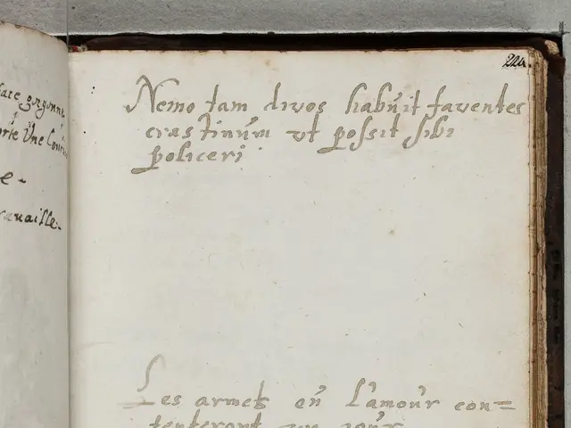 The image shows an open book with writing on it placed on a surface. The book appears to be a...