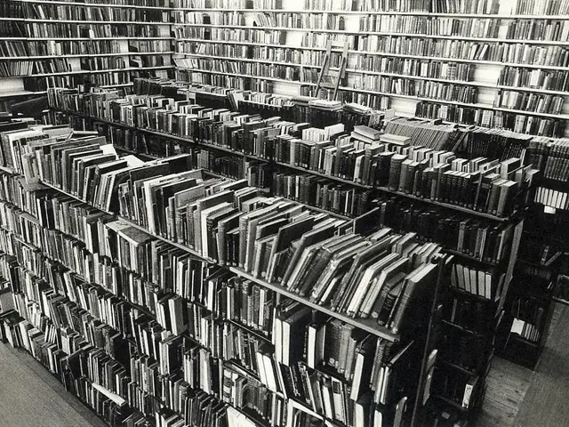 The image shows a black and white photo of a library filled with books arranged in racks. The books...