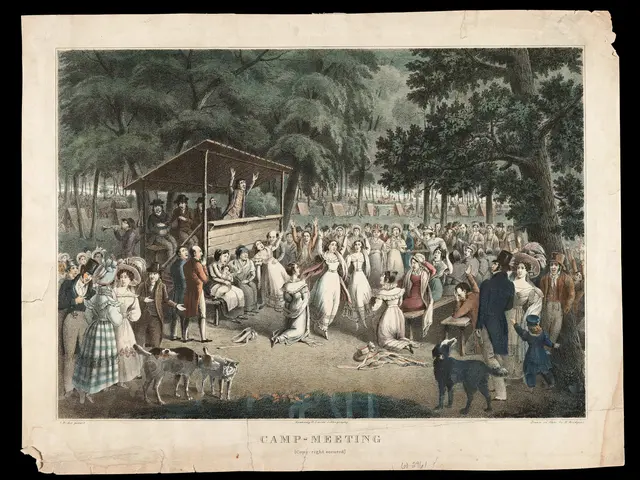 The image shows a group of people gathered in a park, with some sitting and some standing. There...