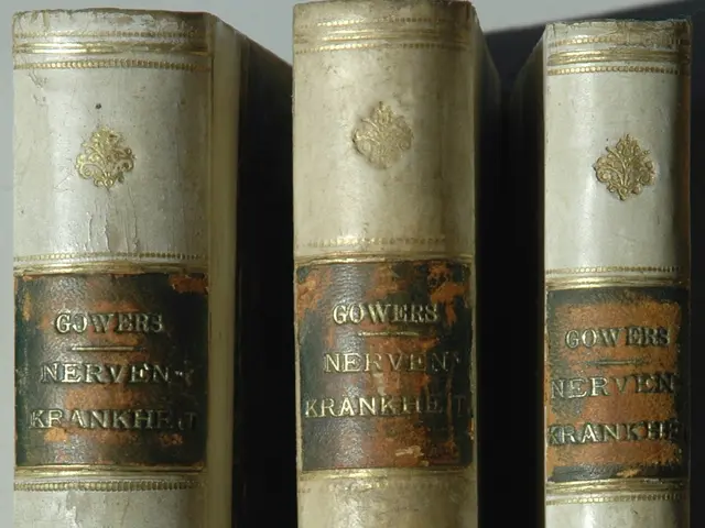 The image shows three books sitting on top of each other on a white surface. The books have text on...