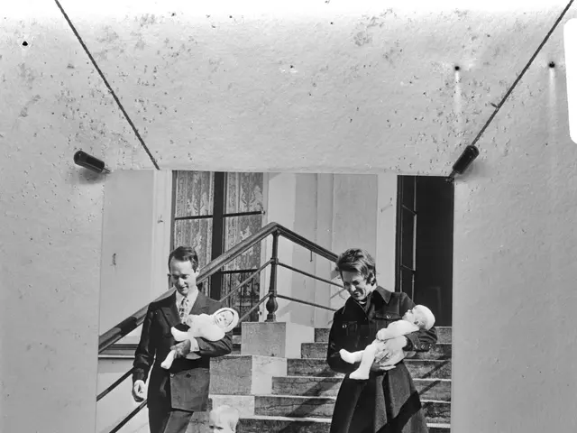 The image shows a black and white photo of a family of three - a man, woman and two children -...