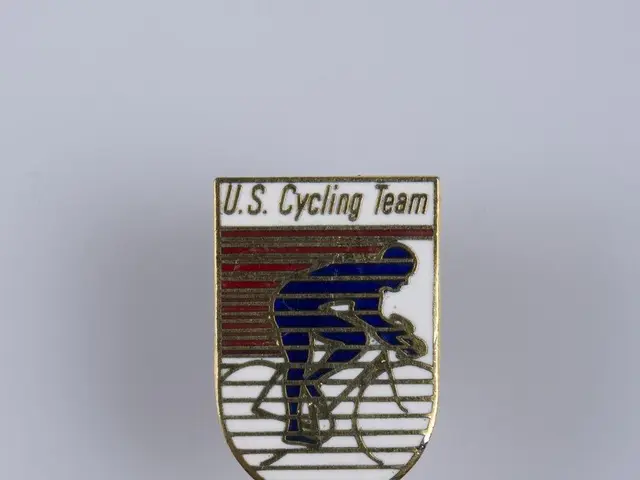 The image shows a white surface with a badge featuring the text "U.S. Cycling Team" and a picture...