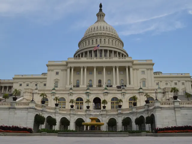 The image shows the United States Capitol Building in Washington, DC. It is a large building with...