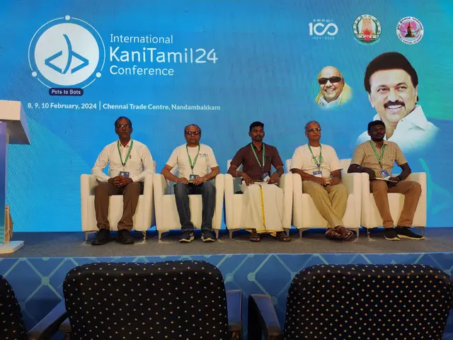 The image shows a group of people sitting on chairs in front of a podium with a microphone, with a...