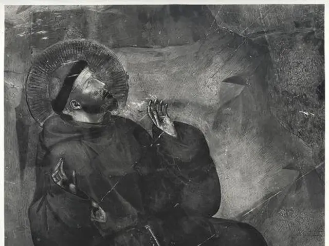 The image shows a black and white photo of Saint Francis of Assisi, the patron saint of the...