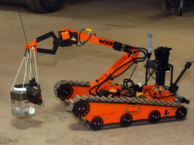 The image shows an orange robot sitting on top of a cement floor, with a vehicle at the top of the...